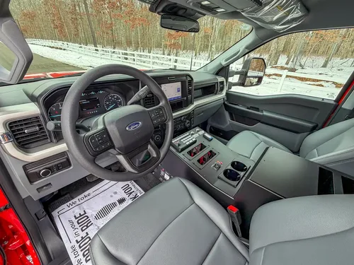 Passenger-side dashboard and steering wheel from cabin interior.